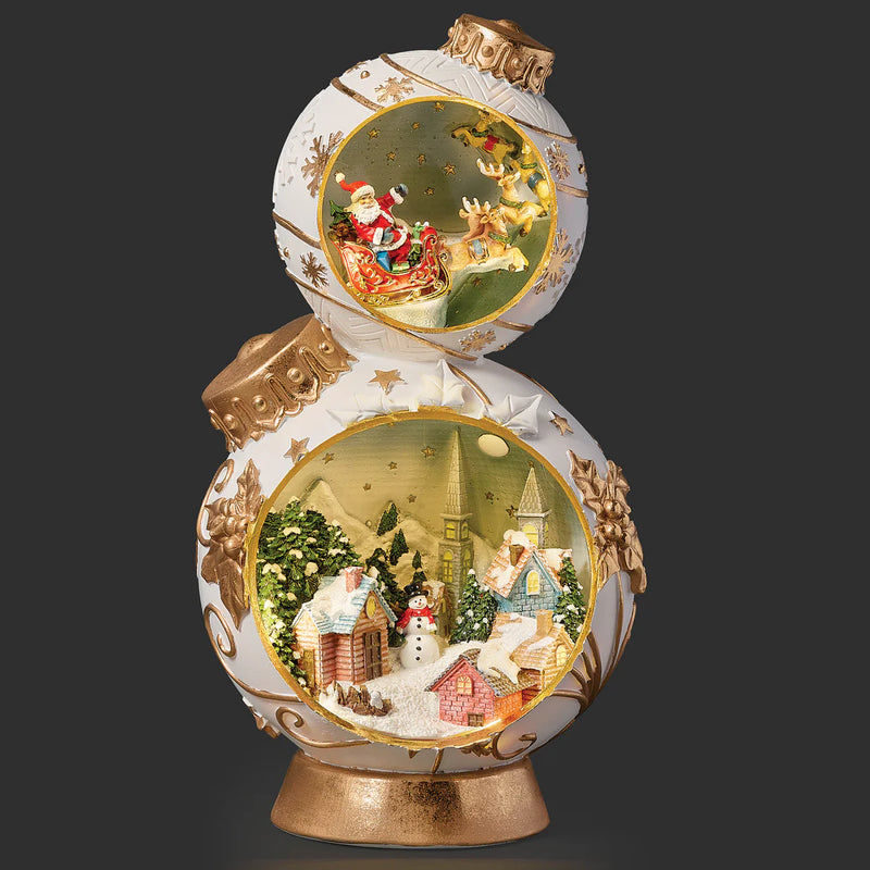 Christmas Ornament Tower with Santa Flying Over Town